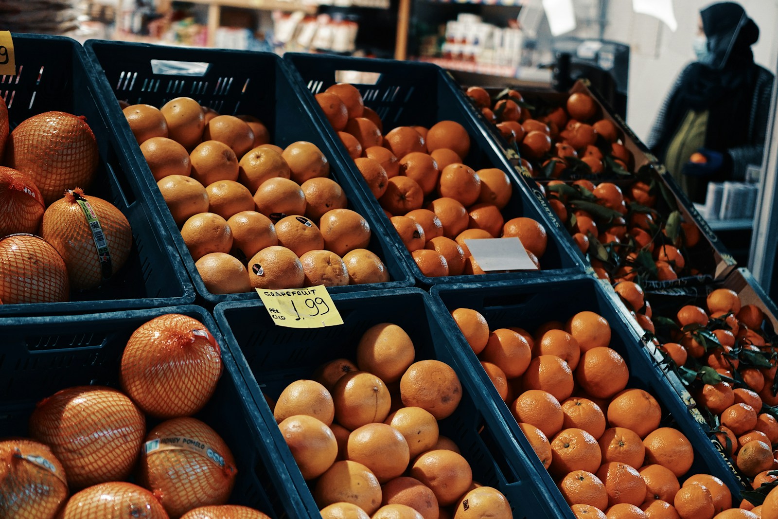 orange fruit on black plastic crate