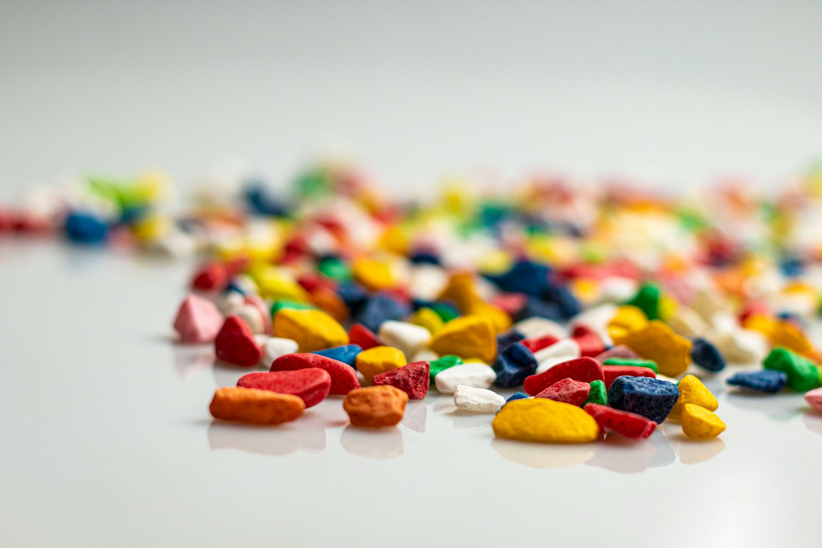 A pile of multicolored candies on a white surface